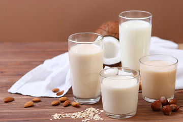 Different types of vegetable milk on the table. Coconut, oatmeal, hazelnut, almond milk. Vegetarian milk.