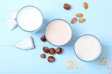 Different types of vegetable milk on the table. Coconut, oatmeal, hazelnut, almond milk. Vegetarian milk.
