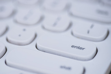 Close-up of Enter key of a white keyboard.