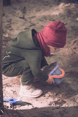 little girl plays in the sand