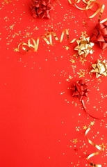 christmas or new year decorations background in gold colors on red background with empty copy space for text. holiday and celebration concept for postcard or invitation. top view 