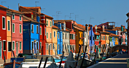 Fototapeta na wymiar Brightly colored houses in a Venetian canal, Burano, Italy