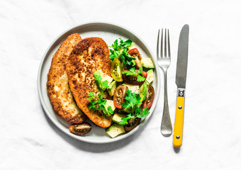 Savory french toast with avocado, cherry tomatoes salad on light background, top view