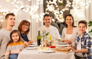 celebration, holidays and people concept - happy family having dinner party at home