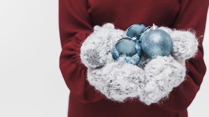 Close-up winter gloves and christmas balls