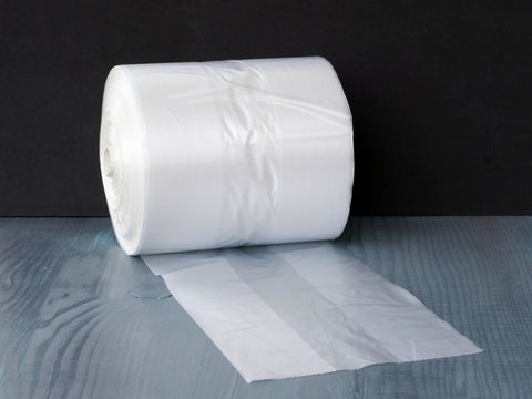 Clear gusseted poly bags on roll over wooden table
