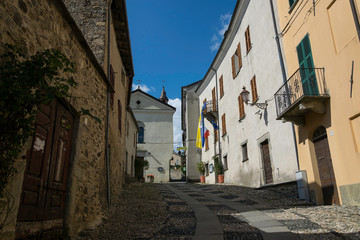 Narrow street in old town with traditional flags
