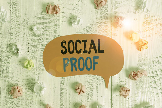 Conceptual hand writing showing Social Proof. Concept meaning informational social influence Psychological Social phenomenon Colored speech bubble paper balls wooden rustic vintage background