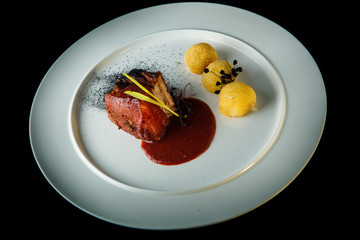 top view of delicious meat with potato balls and red sauce