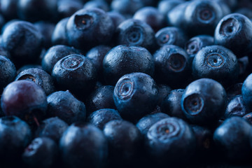 Fresh ripe blueberries with drops of dew. Macro photo. Fresh blueberry background. Texture blueberry berries close up. Ripe bilberry background. Texture bilberry berries close up. Top view. 