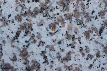 granite wall surface, facade, red-gray with black dots