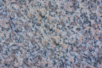 granite wall surface, facade, red-gray with black dots