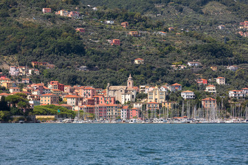 Fototapeta na wymiar View on small city Fezzano from ship. Fezzano is located in province La Spezia, Liguria, close to world famous Portovenere and Cinque Terre. Italy