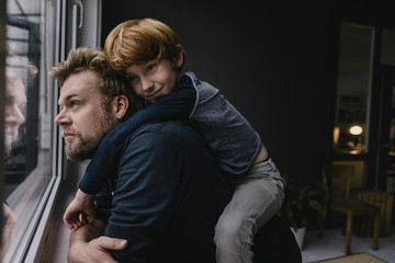 Father and son hanging out at home on rainy day