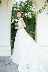 Fototapeta premium Charming Outdoor Bridal Portrait with wedding bouquet
