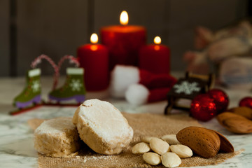 Christmas polvorones and three burning candles