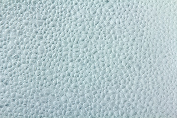 Drops of condensate on the surface of a plastic bottle, close-up
