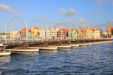 Pontoon bridge and waterfront with harbour and colorful houses in Willemstad, Caribbean.