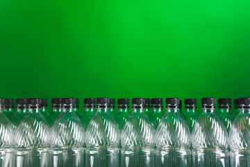 empty plastic bottles on green background