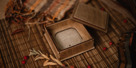 Gift, autumn leaves and berries on wooden background