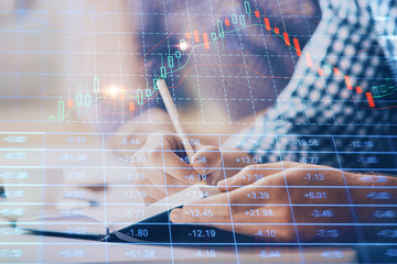 Multi exposure of two men planing investment with stock market forex chart.