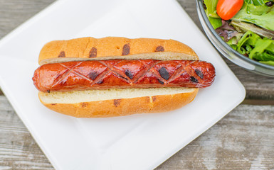 Hot dog on white plate