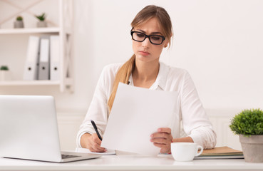 Serious Business Lady Reading Report Taking Notes In Modern Office