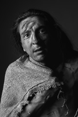 Portrait of a dirty young man with a rough cloth. Black and white.