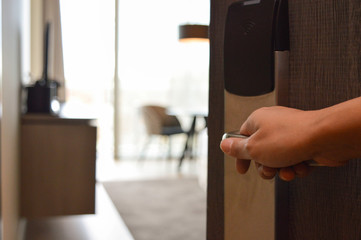 Female hand opening four-star hotel room