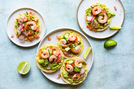 Shrimp tostada with freshly made guacamole, diced tomato and crunchy radish