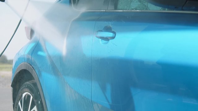 Washing carin self service car wash slow motion close up shot
