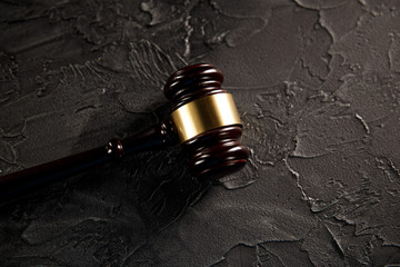 Judge gavel and legal book on wooden table, justice and law concept.