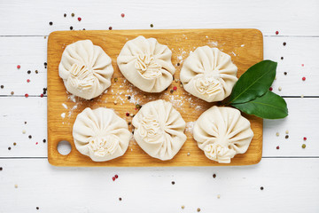 Six Georgian dumpling or Khinkali. Georgian homemade khinkali on cutting board. Top view