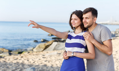 Young couple pointing to something interesting