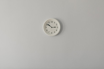 white clock on a white wall