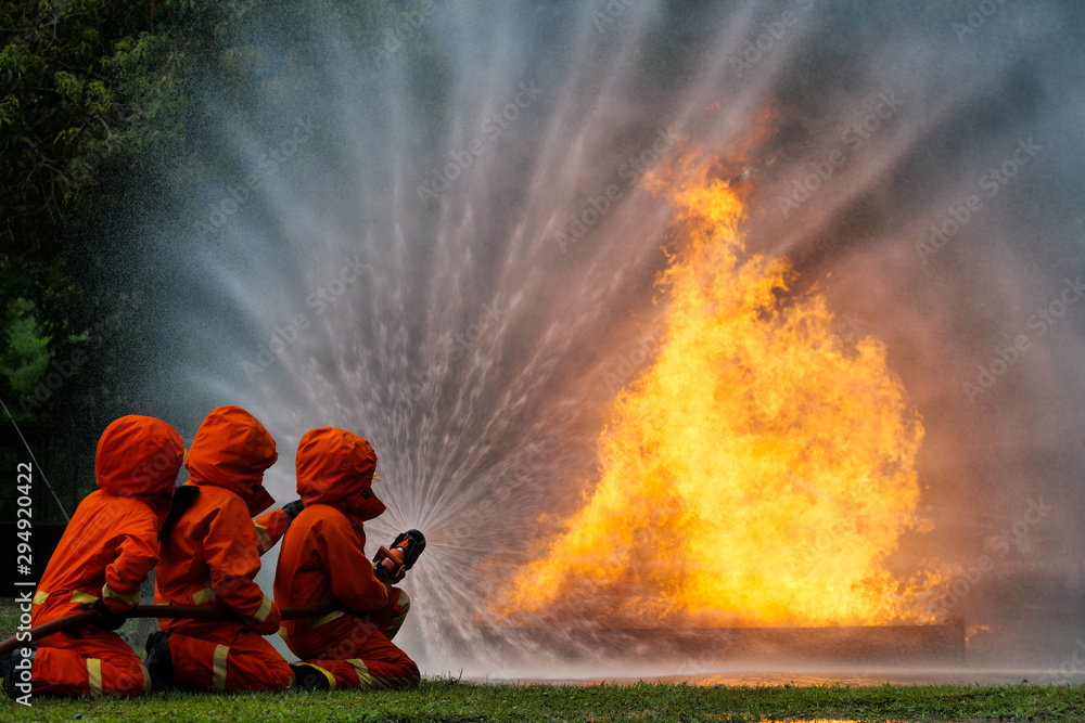 Poster firefighter spray water to fire burning car workshop fire training