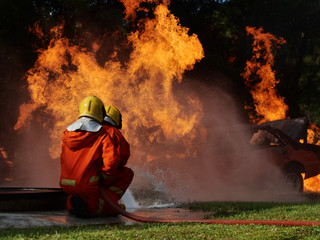 firefighter spray water to fire burning car workshop fire training