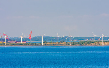 Wind turbines in sea in Copenhagen, Denmark. Offshore wind farm for renewable sustainable and alternative energy production. Green economy. Ecology and environment. Eco power
