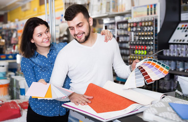 Couple in paint supplies store