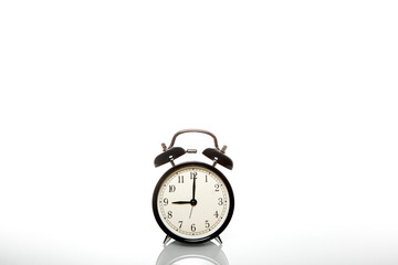 black vintage alarm clock time 9 hours isolated on white background
