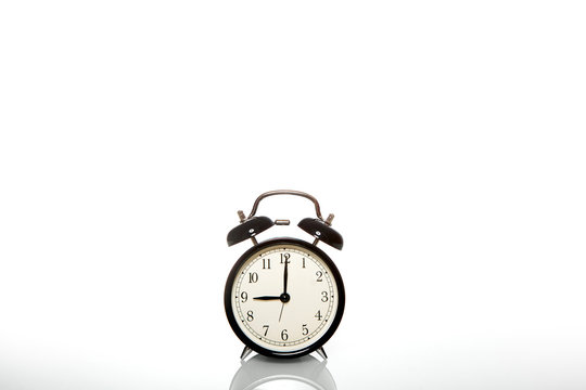 black vintage alarm clock time 9 hours isolated on white background