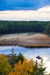Latvian autumn nature. Forest, fog and Kangari lake. View from the top.