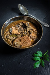 Stewed pork chop in a bright mushroom sauce.
