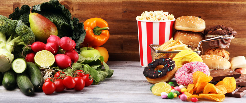healthy or unhealthy food. Concept photo of healthy and unhealthy food. Fruits and vegetables vs donuts and fast food