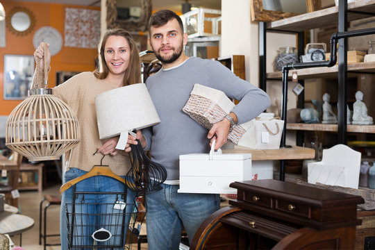 pair standing with purchases in furnishings showroom