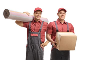 Movers holding a carpet and a box