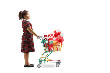 Girl standing with a small shopping cart full of wrapped presents