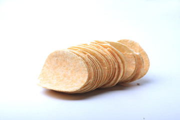 a pile of potato chips on white background