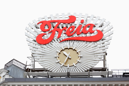 Oslo, Norway - June 20, 2019: The Norwegian chocolate sweets manufacturing company Freia clock at Egertorget square against an overcast sky. chocolate sweets manufacturing company