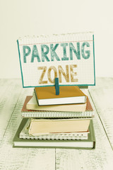 Text sign showing Parking Zone. Business photo text a space where an automobile can be parked Allowed to parked pile stacked books notebook pin clothespin colored reminder white wooden